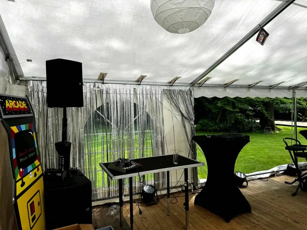 Espace DJ et borne arcade dans un chapiteau 6x15 pour fête familiale thème années 90